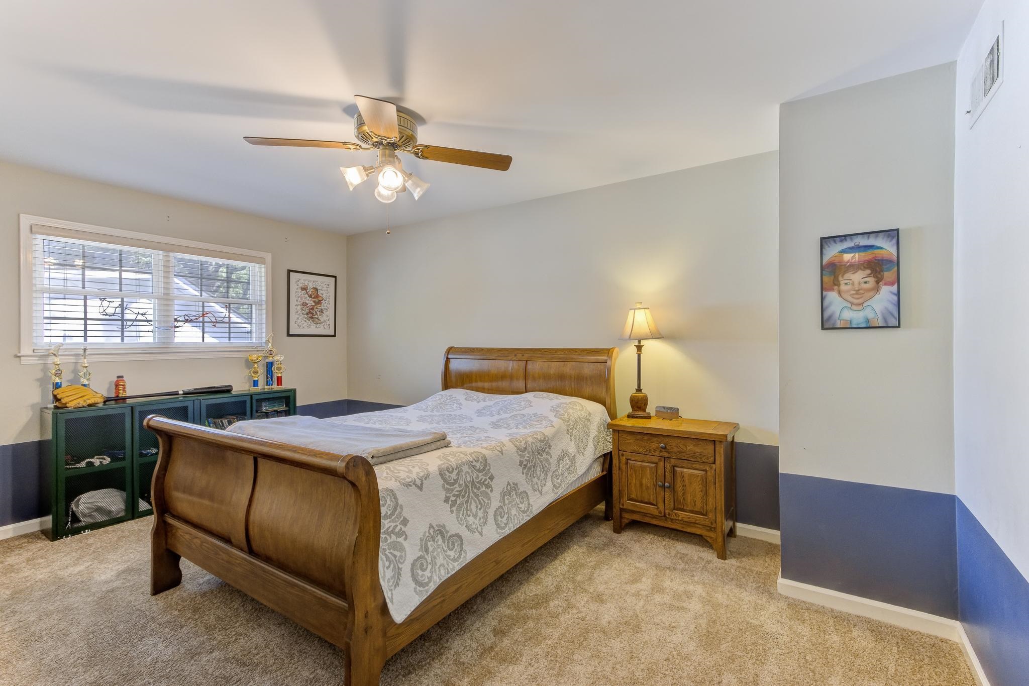 4414 Walnut Grove Road Memphis, TN 38117 - Photo 32 of 40 a bedroom with a bed and a chandelier