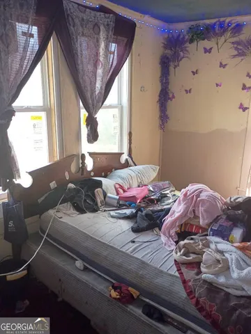 a bedroom with a bed and a window