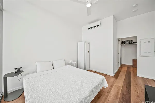 a bedroom with a bed and wooden floor