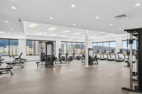 a view of a room with gym equipment and floor to ceiling window
