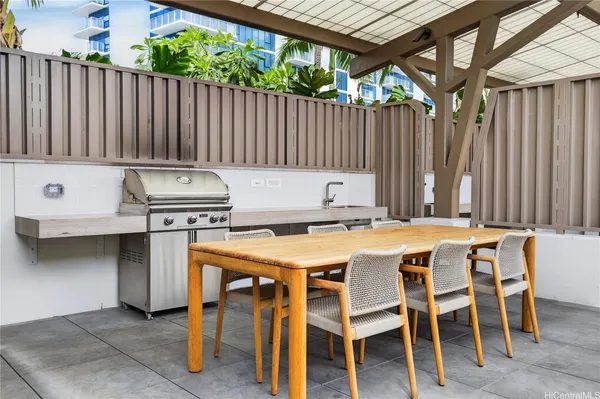 a table and chairs in a patio with wooden fence