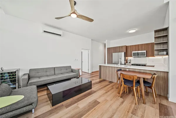 a living room with furniture and a wooden floor