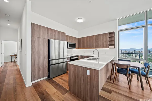 a kitchen with a table chairs refrigerator and a sink