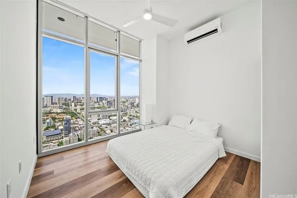 a large white bed in a white room