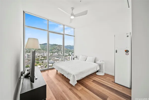 a living room with a bed furniture and a large window