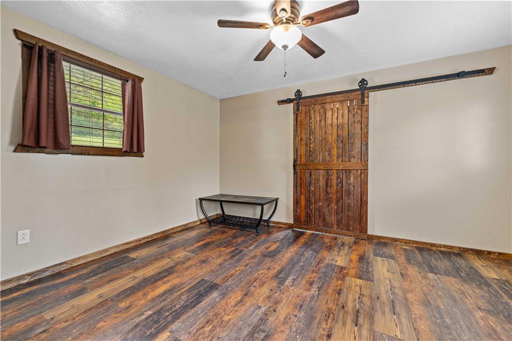 645 New Geneva Road Point Marion, PA 15474 - Photo 27 of 36 wooden floor in an empty room with a window