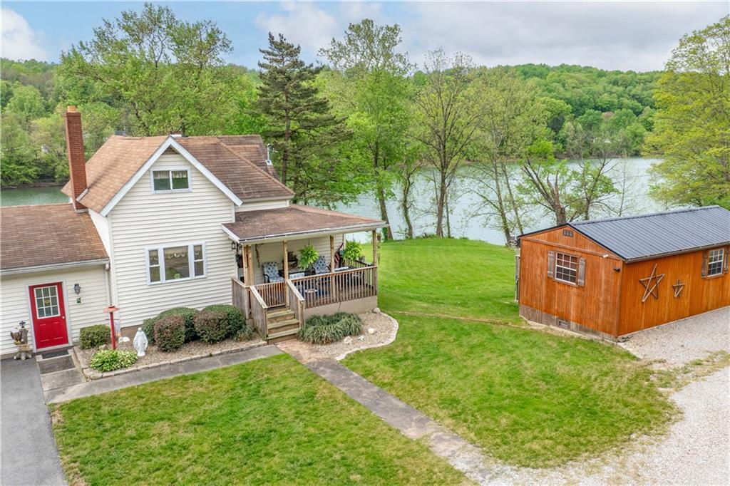 645 New Geneva Road Point Marion, PA 15474 - Photo 36 of 36 a aerial view of a house with backyard porch and sitting area