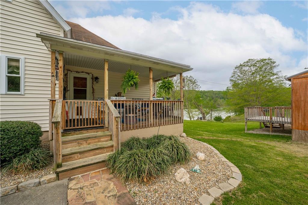 645 New Geneva Road Point Marion, PA 15474 - Photo 6 of 36 a view of a house with a small yard and a garden