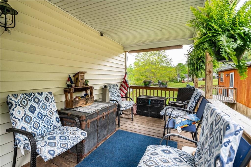 645 New Geneva Road Point Marion, PA 15474 - Photo 7 of 36 a balcony with furniture and a potted plant