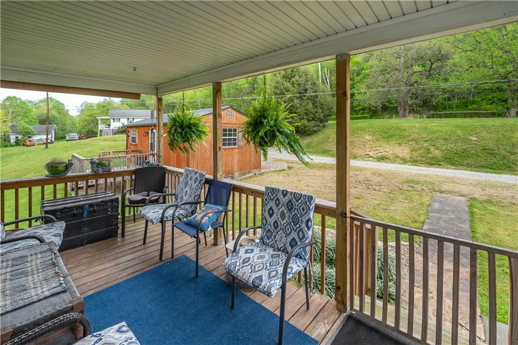 645 New Geneva Road Point Marion, PA 15474 - Photo 8 of 36 a view of a porch with furniture and wooden floor