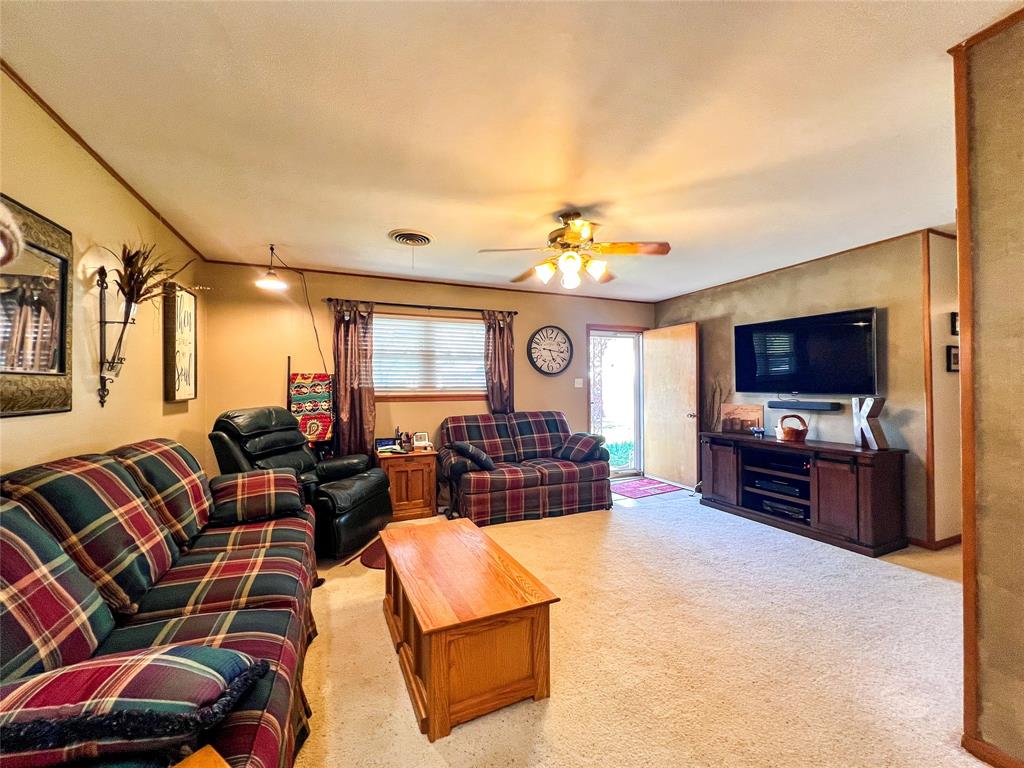 1009 North 7th Street Haskell, TX 79521 - Photo 6 of 26 a living room with furniture and a flat screen tv