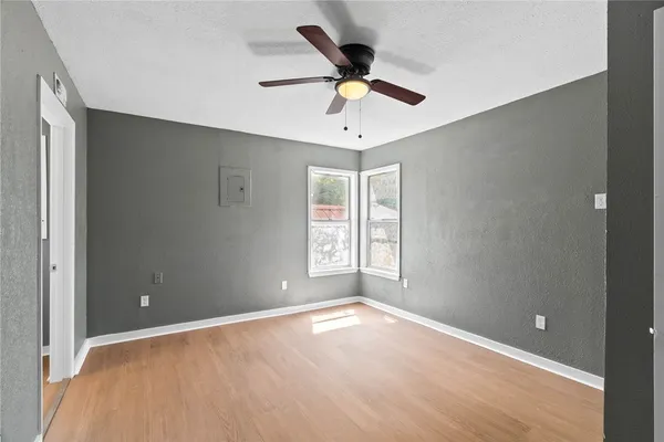 wooden floor in an empty room with a window