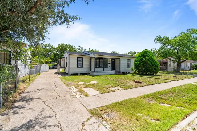 a view of house with yard and swimming pool