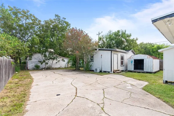 a backyard of a house with table and chairs
