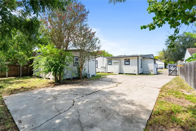 a view of a house with a yard and garage