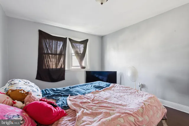 a bedroom with a bed and window