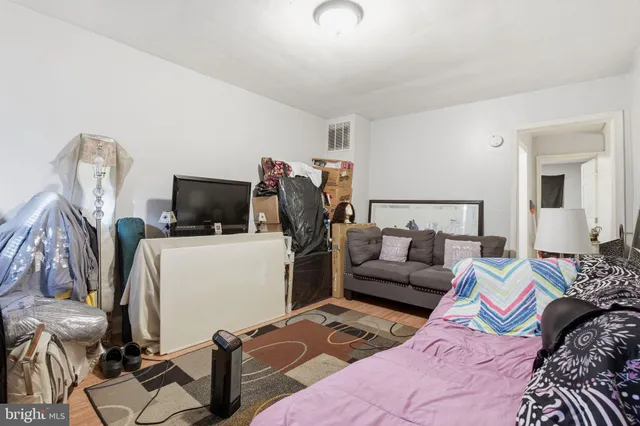 a bed room with a bed a couch and a television