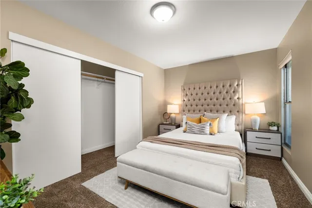 a bedroom with a bed and a potted plant