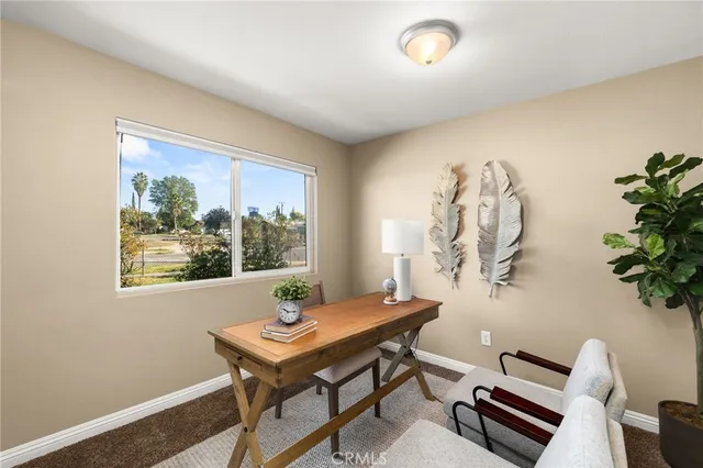 a view of a dining room with furniture and a potted plant