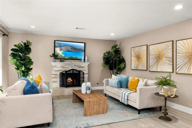 a living room with furniture fireplace and potted plant