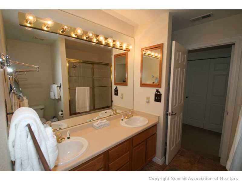 487 Main Street, Unit A Frisco, CO 80443 - Photo 11 of 22 a bathroom with a sink vanity granite shower and a mirror