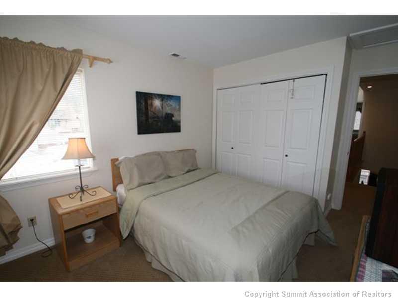 487 Main Street, Unit A Frisco, CO 80443 - Photo 12 of 22 a bedroom with a bed and a window