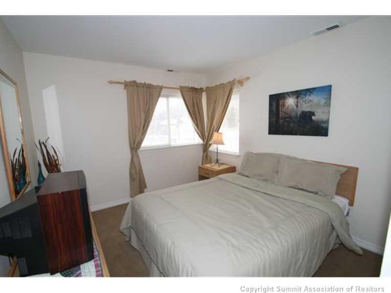 487 Main Street, Unit A Frisco, CO 80443 - Photo 13 of 22 a bedroom with a bed and a flat screen tv