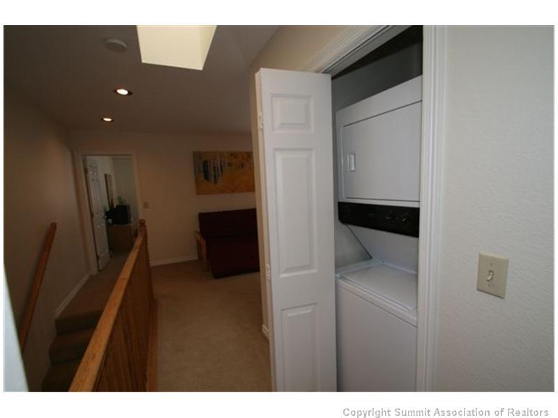 487 Main Street, Unit A Frisco, CO 80443 - Photo 17 of 22 a kitchen with stainless steel appliances a refrigerator and a sink