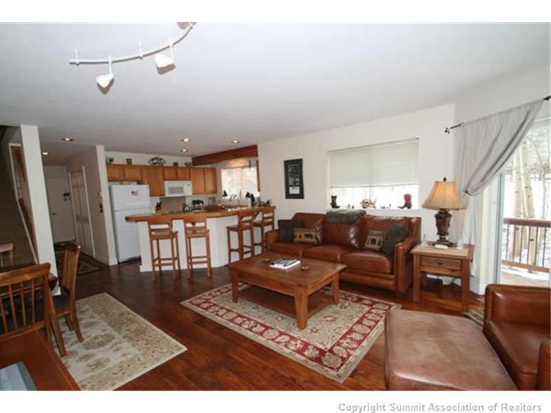 487 Main Street, Unit A Frisco, CO 80443 - Photo 3 of 22 a living room with lots of furniture and kitchen view
