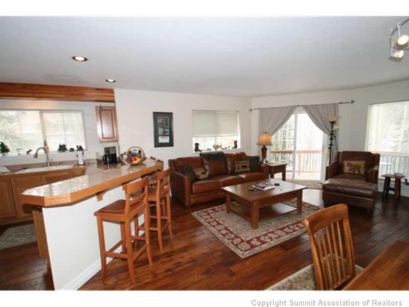 487 Main Street, Unit A Frisco, CO 80443 - Photo 6 of 22 a living room with furniture a large window and a chandelier