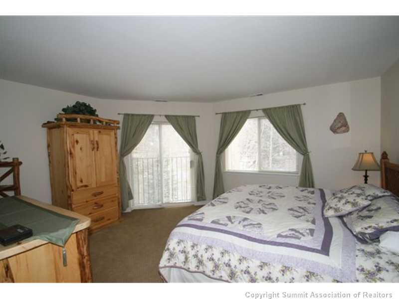 487 Main Street, Unit A Frisco, CO 80443 - Photo 9 of 22 a bedroom with a bed and a window
