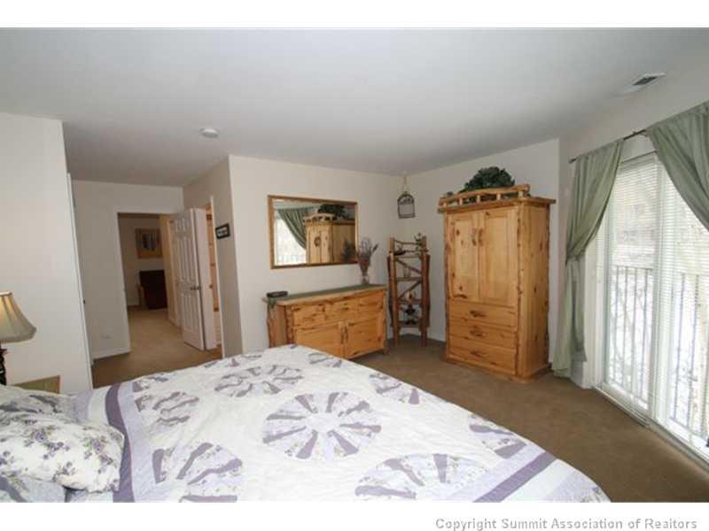 487 Main Street, Unit A Frisco, CO 80443 - Photo 10 of 22 a bed room with a bed and a television