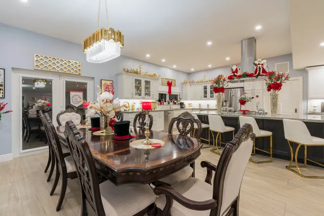 a bedroom with a bed a large window and book shelf