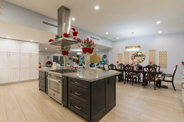 a view of a patio with table and chairs potted plants and palm tree