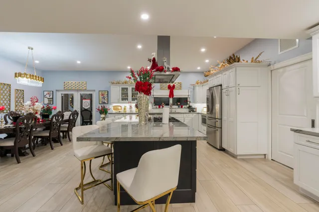 a view of a lake from a balcony with outdoor seating