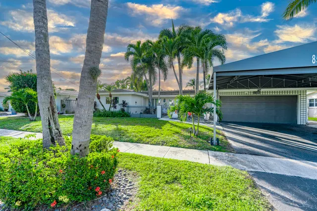 a living room with furniture kitchen and a chandelier
