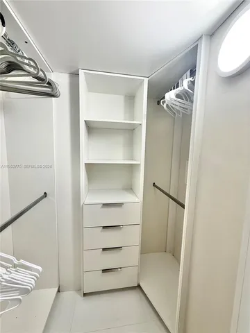 a bathroom with a walk in closet