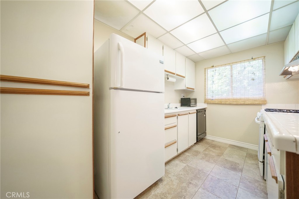 2255 Cahuilla Street, Unit 32 Colton, CA 92324 - Photo 15 of 35 a kitchen with a refrigerator a stove a washer and dryer