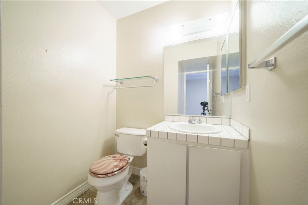 2255 Cahuilla Street, Unit 32 Colton, CA 92324 - Photo 24 of 35 a bathroom with a sink toilet and mirror