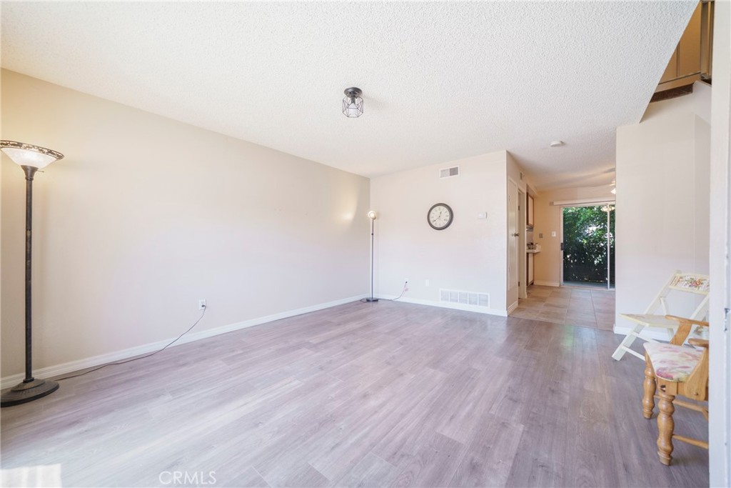 2255 Cahuilla Street, Unit 32 Colton, CA 92324 - Photo 10 of 35 an empty room with wooden floor and windows