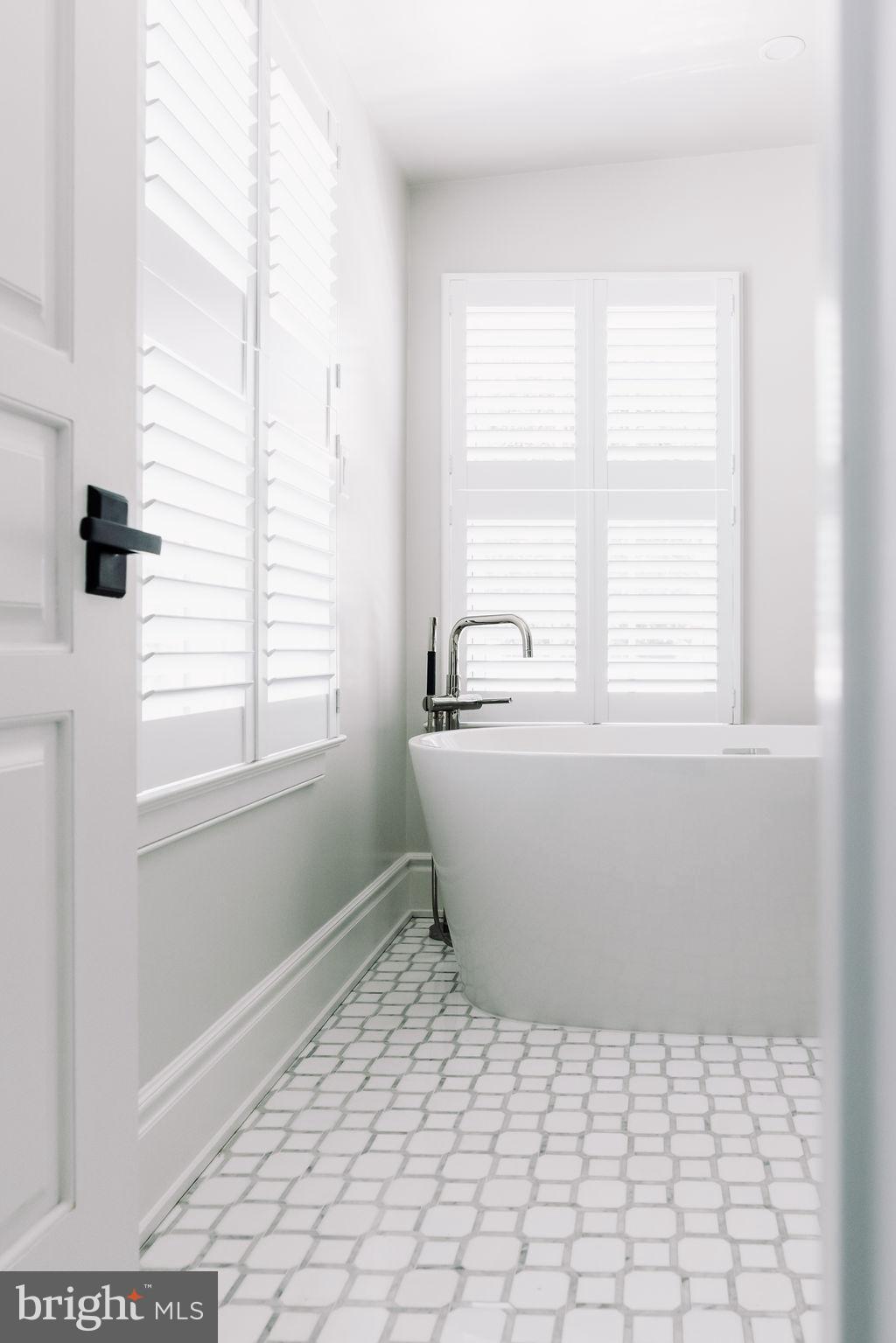 400 G Street Southeast Washington, DC 20003 - Photo 27 of 56 a white bath tub sitting in a bathroom next to a window