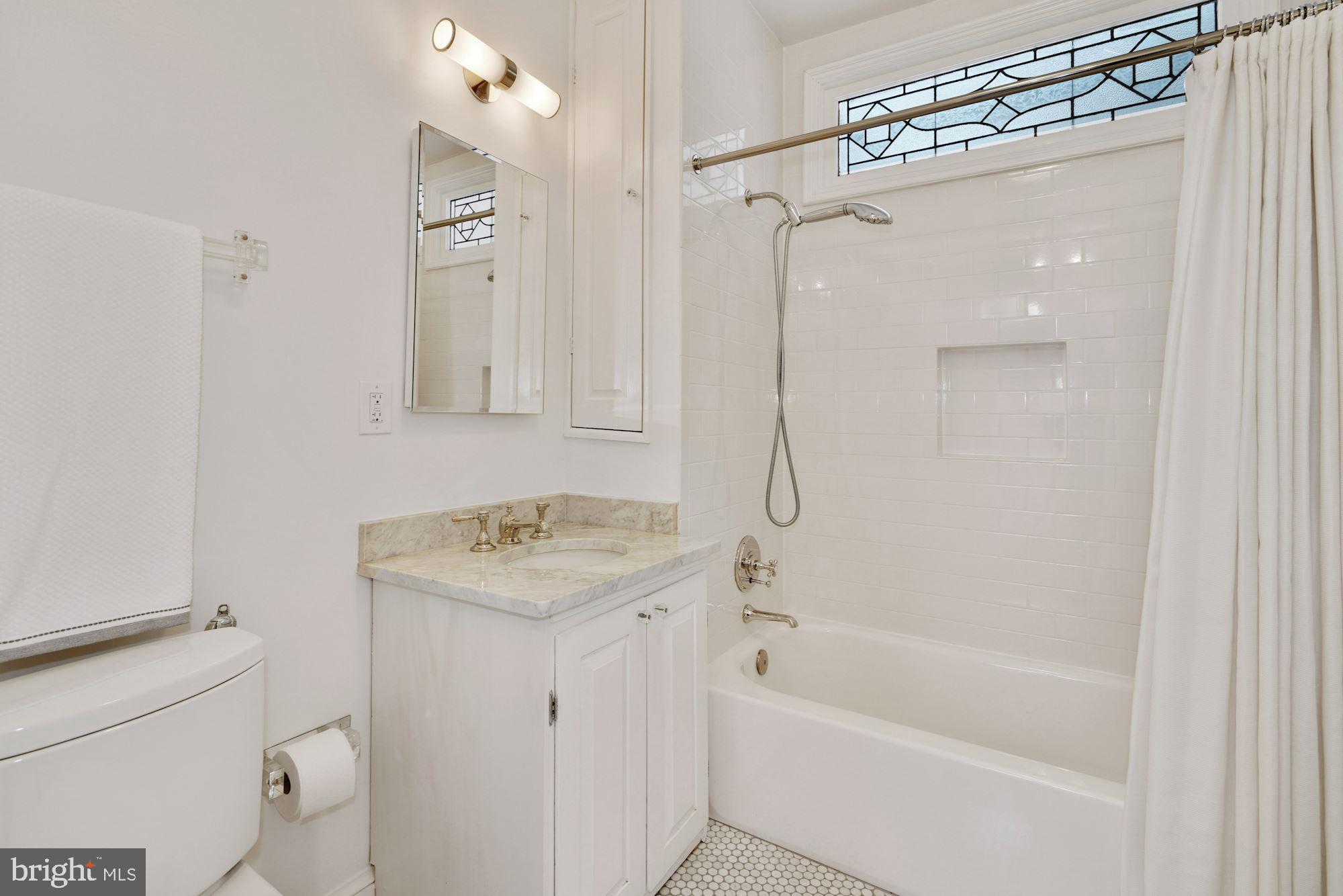 400 G Street Southeast Washington, DC 20003 - Photo 32 of 56 a bathroom with a sink toilet vanity and shower