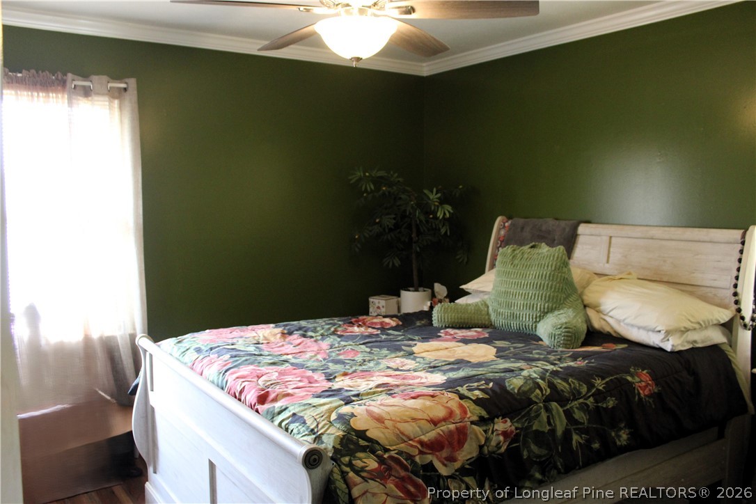 2038 Dunn Road Eastover, NC 28312 - Photo 14 of 29 a bedroom with a bed and a potted plant