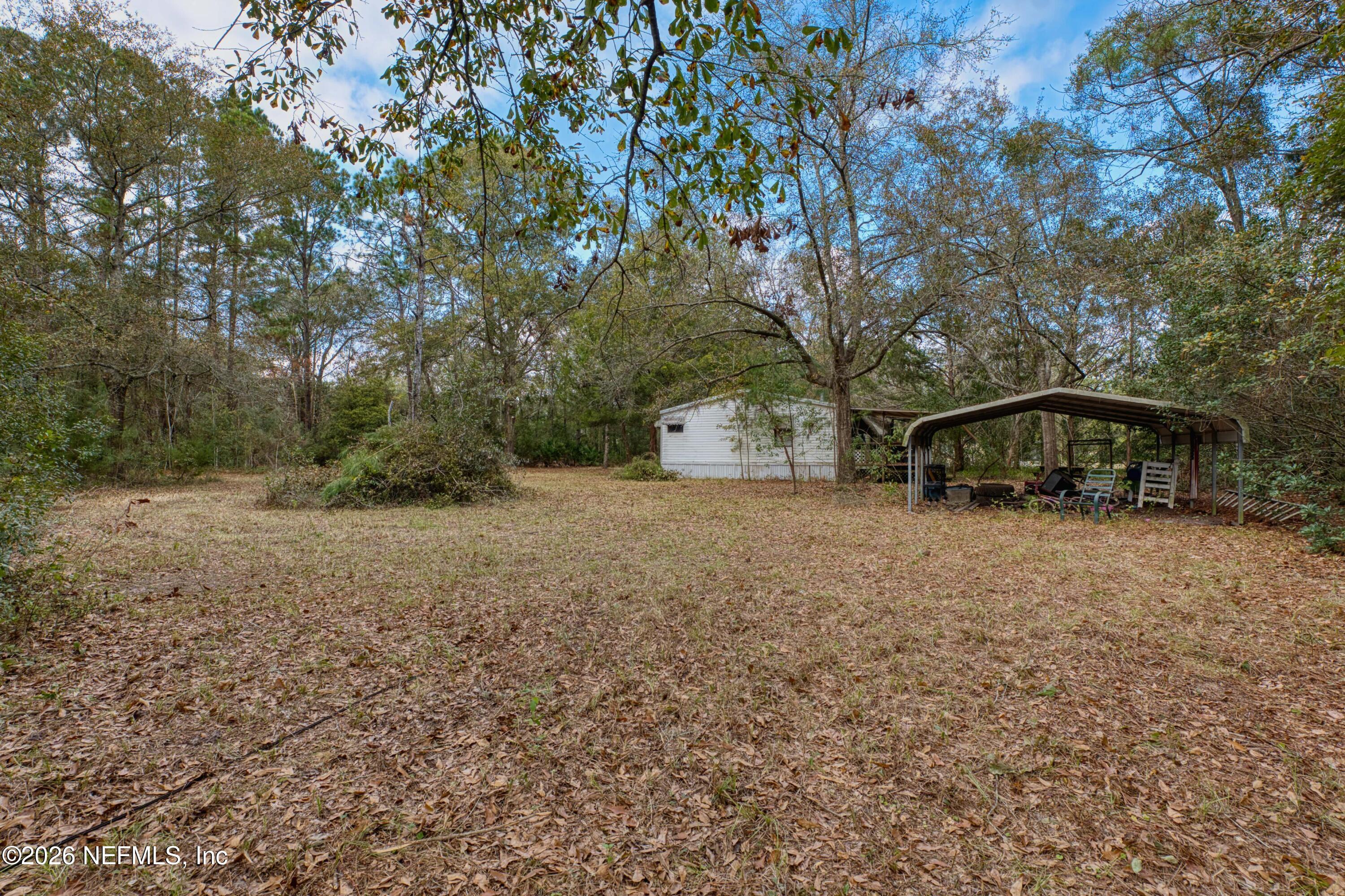 1049 Hammond Boulevard Jacksonville, FL 32221 - Photo 13 of 16 a view of a house with backyard and trees