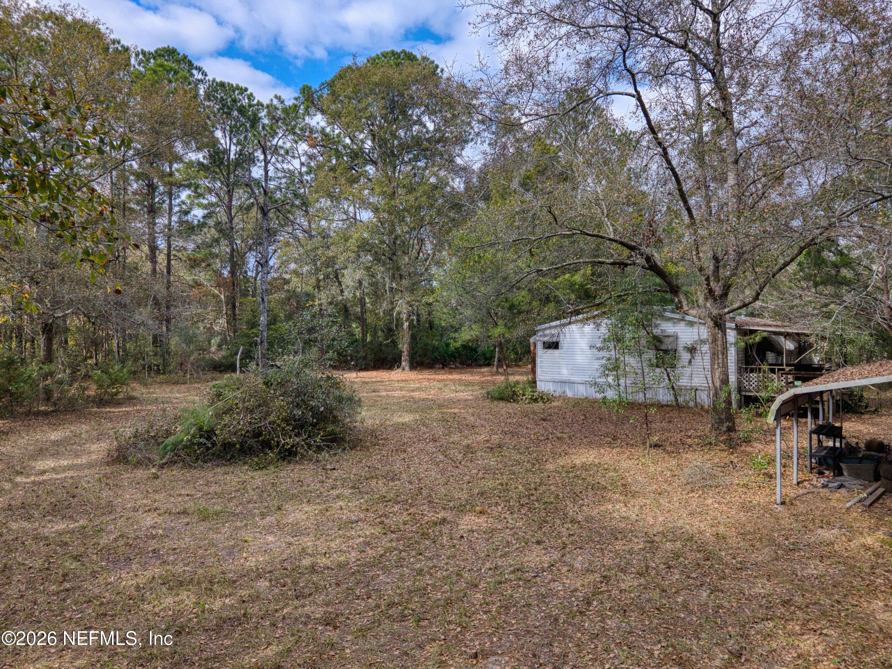 1049 Hammond Boulevard Jacksonville, FL 32221 - Photo 8 of 16 a view of a chairs in a backyard