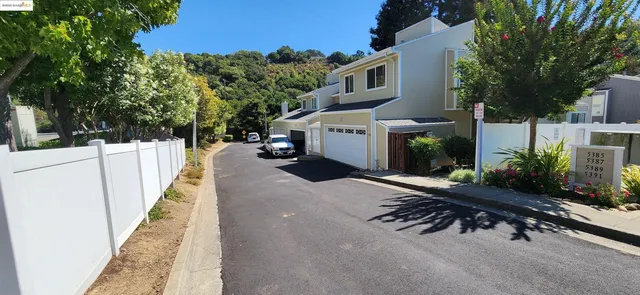 a street sign on a sidewalk next to a road