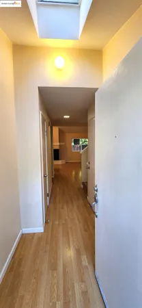 a view of a hallway with wooden floor