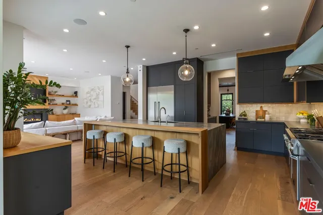 a large kitchen with a table and chairs in it