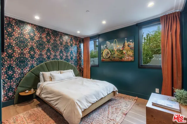 a bedroom with a large bed and a large window