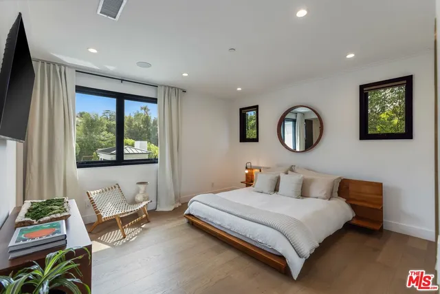 a bedroom with a large bed and a window